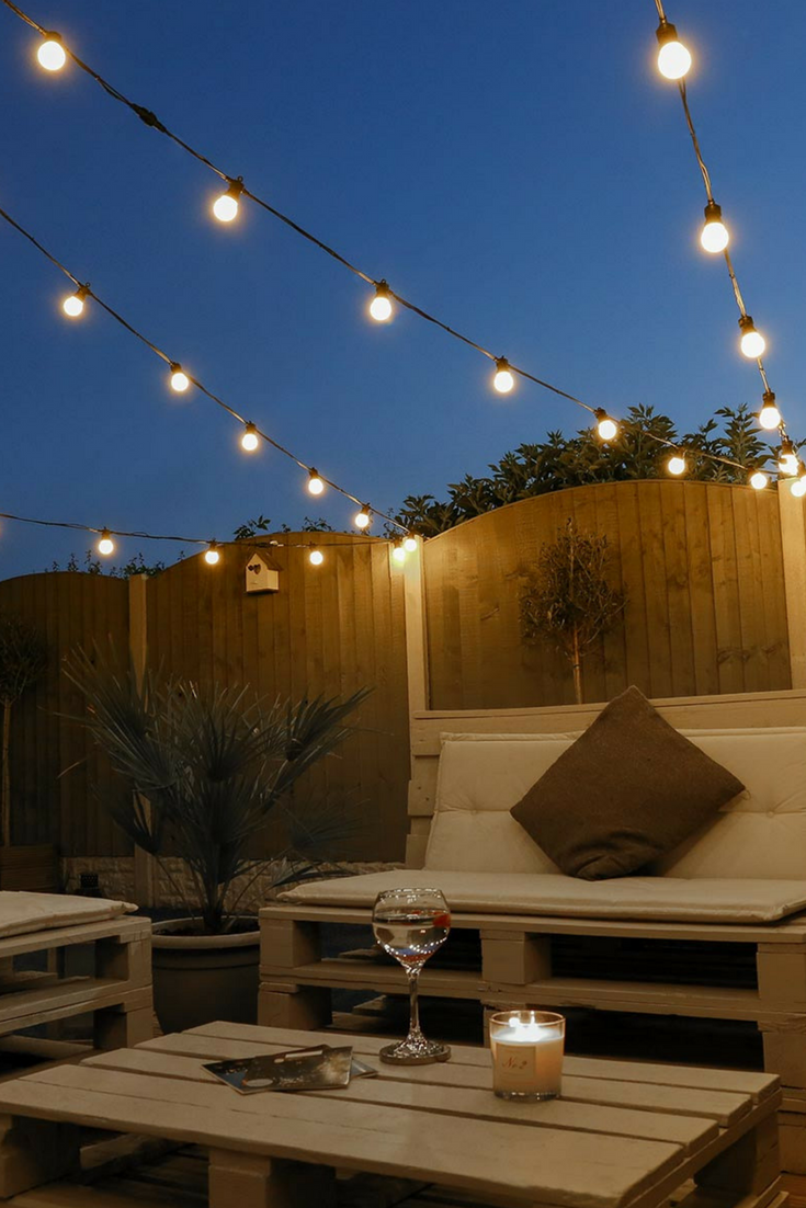 Solar festoon lights with warm white globes hanging outside