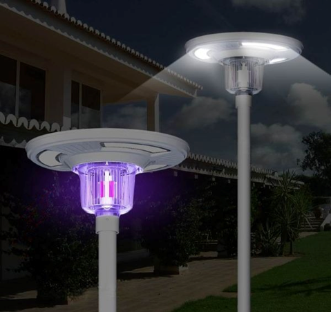 Solar-powered park light with insect zapper feature, mounted on a post with a built-in solar panel on top