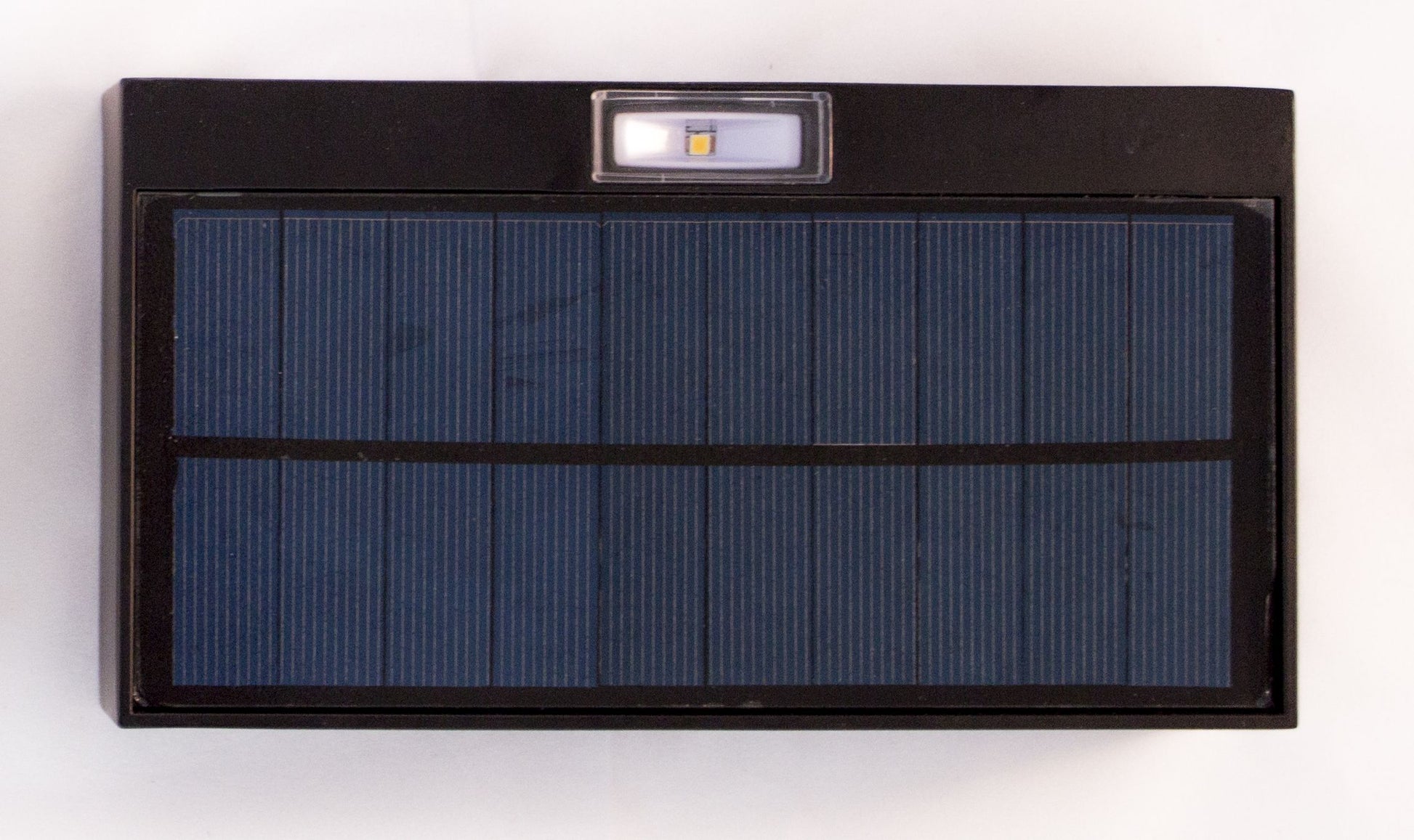 A rectangular black LED up/down solar wall light with a solar panel on top and built-in LEDs.
