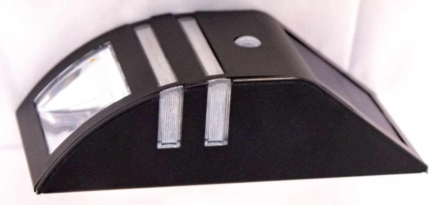 A black stainless steel step light with a built-in solar panel and motion sensor, designed for outdoor installation.