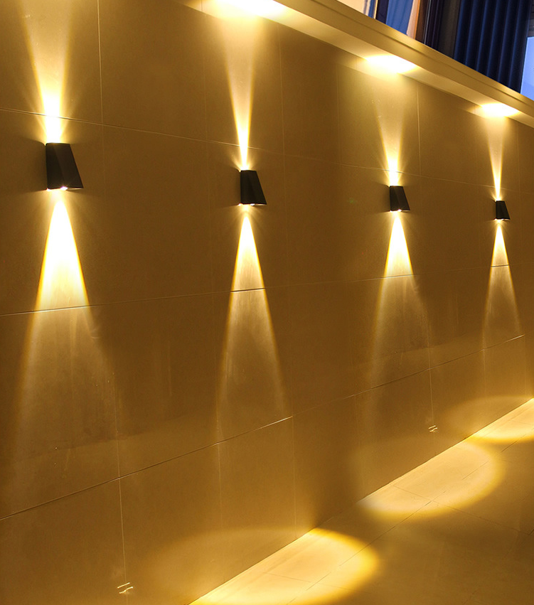 Black LED up/down solar wall light with a solar panel, constructed from machined aluminium shown mounted on a wall