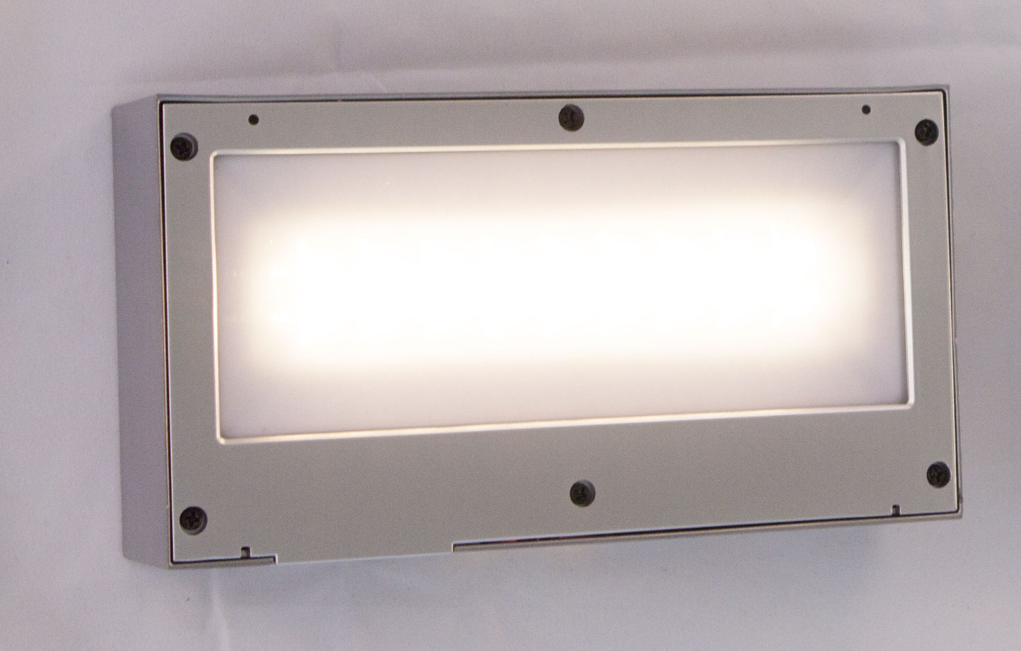 A rectangular silver LED up/down solar wall light with a solar panel on top and built-in LEDs.