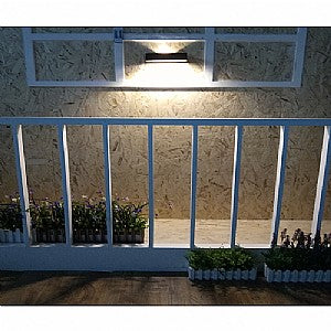 A rectangular LED up/down solar wall light shown on a wall