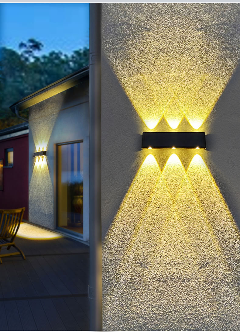 Black LED up/down solar wall light fixture with a solar panel on the front shown mounted on a wall